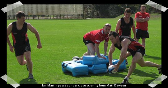 Ian Martin passes under close scrunity from Matt Dawson